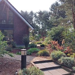 Front garden of Holiday Home in Ommen, Vecht region, Overijssel, with flowering plants.