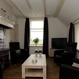 Cozy living room in Cottage in Dalfsen, cottage in the Vecht region, Overijssel with comfortable sitting area and views of nature.