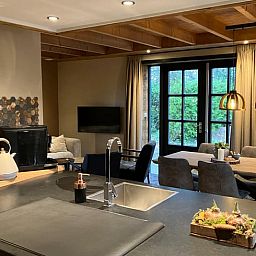 Cozy indoor area of Holiday Home in Giethmen, Overijssel, with modern kitchen and spacious dining area, ideal for relaxing vacations.