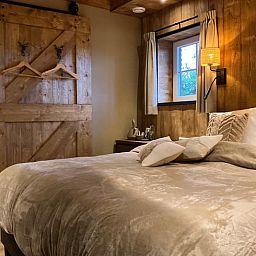 Attractive bedroom in Holiday cottage in Giethmen, Vechtstreek, Overijssel with wooden interior and comfortable beds.