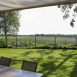 View from the terrace of Cottage in Radewijk over the green fields in the Vecht region.