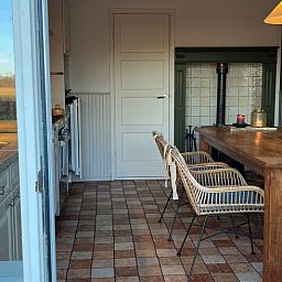 Gezellige eetruimte in Vakantiehuisje in Den Velde, Overijssel, met uitzicht op de Vechtstreek en een warme, landelijke sfeer.