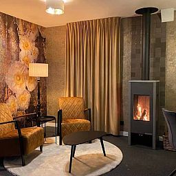 Cozy sitting area with fireplace in Cottage in Kloosterhaar, Vechtstreek, Overijssel.