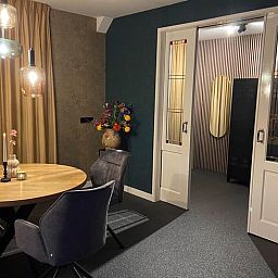 Stylish dining room with flower vase in Holiday cottage in Kloosterhaar, Vechtstreek, Overijssel.