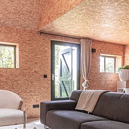 Cozy living room of cottage in Kloosterhaar, Vecht region Overijssel, with modern decor and lots of natural light.