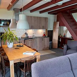 Cozy indoor area of vacation home OV602 in Giethoorn with modern kitchen and dining table.