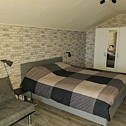 Cozy living room in a vacation home in Zwartsluis, Northwest Overijssel, with a view of nature from the spacious interior.