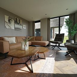 Stylish living room in a detached house in Kampen, Northwest Overijssel, with modern furnishings and views of the natural surroundings.