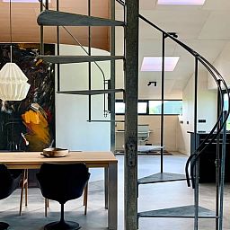 Modern interior space with spiral staircase in Holiday home in Zalk, perfect for a relaxing stay in Overijssel.