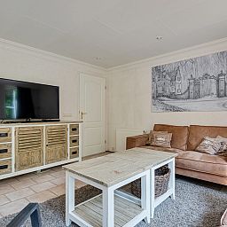 Gezellige woonkamer in Vakantiewoning Drieburg, Doorn, Utrechtse Heuvelrug. Comfortabele zitruimte met landelijke uitstraling.