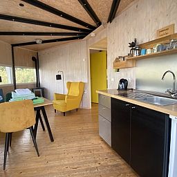 Cozy indoor area of Cottage in IJsselstein, Utrecht. Vacation home with modern kitchen and cozy sitting area for a relaxing stay.