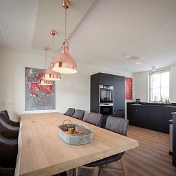 Dining room with wooden table in Holiday Home Ganuenta, Colijnsplaat, North Beveland, ideal for cozy dinners.