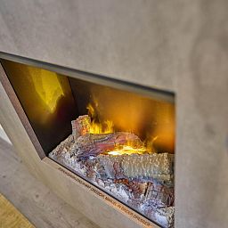 Cozy fireplace in Sauna Zee 27H, a vacation home in Colijnsplaat, North Beveland, Zeeland, offers cozy warmth and atmosphere.