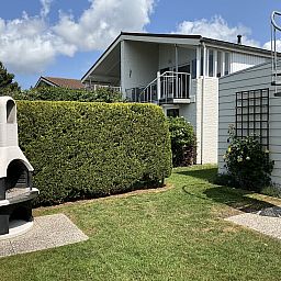 Exterior with stairs and barbecue at Ostrea 16 vacation home, Roompot Beach Resort, Kamperland, Zeeland.