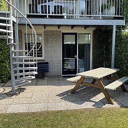Veranda with picnic table at Ostrea 16 vacation home, Roompot Beach Resort, Kamperland, Zeeland.