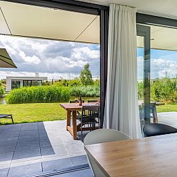 Sunny terrace at Duinvallei 10 | De Groote Duynen in Kamperland, a vacation home overlooking the green surroundings of North Beveland.
