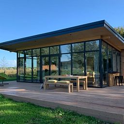 Stylish vacation home in Kamperland with glass facades and spacious outdoor space in North Beveland, Zeeland.