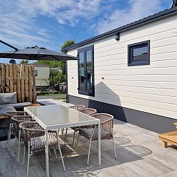 Enjoy the terrace of VZ2326 Holiday Chalet Stern 1866 Renesse, ideal for outdoor dining in Schouwen-Duiveland, Zeeland.