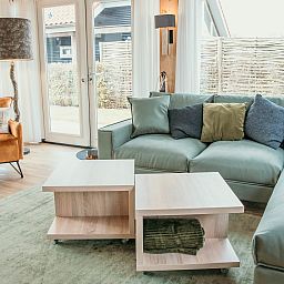 Bright living room of Mon Repos in Renesse with comfortable sofa and modern furnishings