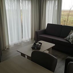 Lichte binnenruimte van Vakantiehuisje in Kerkwerve met uitzicht op natuur.