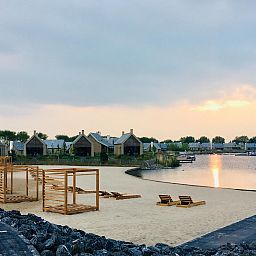 Beach at Oesterdam Resort in Tholen, Zeeland with beautiful waterfront sunset.