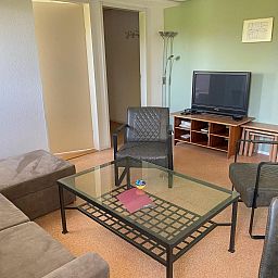 Modern living room with TV in VZ034 Apartment Koudekerke, vacation home in Koudekerke, Walcheren, perfect for relaxation.