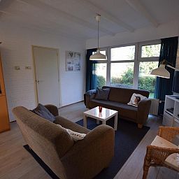 Cozy living room of VZ1163 Holiday bungalow in Oostkapelle, Walcheren, Zeeland with comfortable sofas.