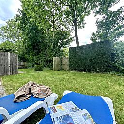 Relax in the garden of Apartment Boszicht 1, Oostkapelle, Walcheren, with deck chairs and privacy.