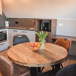 Modern kitchen in vacation home ZE1315, Westkapelle, Walcheren, Zeeland with white cabinets and gray countertop.