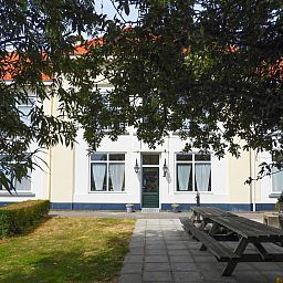 Terrace with picnic tables at VZ131 Group accommodation Westkapelle, vacation home in Zeeland.