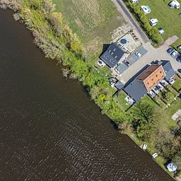 Sunny terrace at vacation home ZE1151 in Veere, Walcheren, Zeeland, ideal for outdoor meals.
