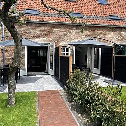Rustic exterior of VZ1022 Holiday apartment in Veere, Walcheren, Zeeland with sunny terrace.