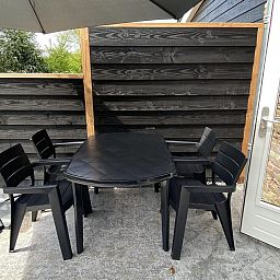Outdoor table with parasol at VZ1022 Holiday apartment in Veere, Walcheren, Zeeland.