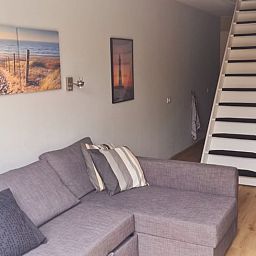Cozy living room in Holiday home in Breskens, Zeeuws-Vlaanderen, Zeeland. Relaxed atmosphere with comfortable sofa.