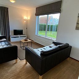Cozy living room of VZ921 Holiday home in Cadzand-Bad overlooking the garden, Zeeland.