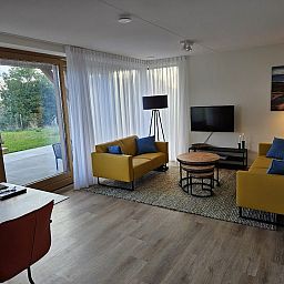 Gezellige woonkamer van Vrijstaande woning in Cadzand, Zeeuws-Vlaanderen, met uitzicht op terras en natuur.