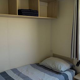 Gezellige slaapkamer in Vakantiehuisje in Hengstdijk, Zeeuws-Vlaanderen, met comfortabele bedden en uitzicht op de rustige natuur van Zeeland.