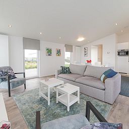 Bright living room of Holiday home Waterresort Oosterschelde - house no. 38 in Wemeldinge with comfortable furniture.