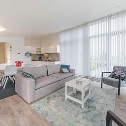 Spacious living room and dining area in Holiday home Waterresort Oosterschelde - house no. 38 in Wemeldinge, South Beveland.