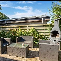 Enjoy the sunny garden with terrace and barbecue at vacation home Scheldeoord 54 in Baarland, Zuid-Beveland, Zeeland.