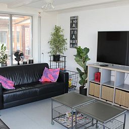 Modern living room of Cottage in Lewedorp with comfortable seating area in South Beveland, Zeeland.