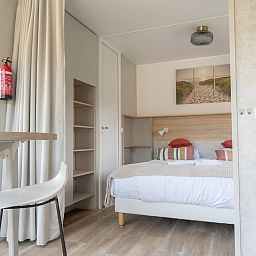 Comfortable bedroom in Hotel Chalet Westerduin, Ouddorp with double bed and stylish decoration.