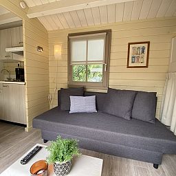 Cozy interior of Camping Chalet the Albatros Plus in Ouddorp, Goeree-Overflakkee, South Holland with comfortable seating area.