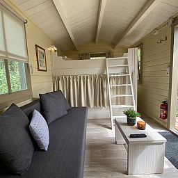 Cozy interior of Camping Chalet the Albatros Plus in Ouddorp, South Holland, with comfortable seating area and views of nature.