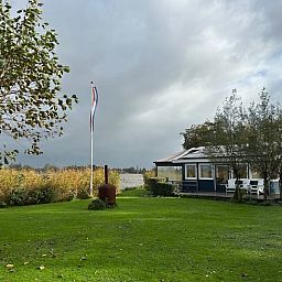 Cozy living room of Holiday home in Reeuwijk overlooking the water, ideally located in the Green Heart of South Holland.
