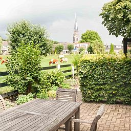 Terrace overlooking green fields at Holiday home in Nieuwveen, Green Heart, South Holland.