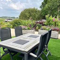 Enjoy the terrace at Holiday Home in Noorden, Green Heart, South Holland, surrounded by lush nature and rustic charm.