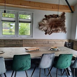 Gemuetliches Esszimmer im Ferienhaus in Gouderak, Suedholland, mit Blick auf die gruene Umgebung des Gruenen Herzens.