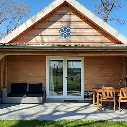 Vacation home in Hazerswoude-Rijndijk with wooden veranda and garden view, located in the Green Heart of South Holland.