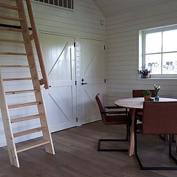 Cozy interior of vacation home in Hazerswoude-Rijndijk, Green Heart, with wooden interior and dining area in South Holland.